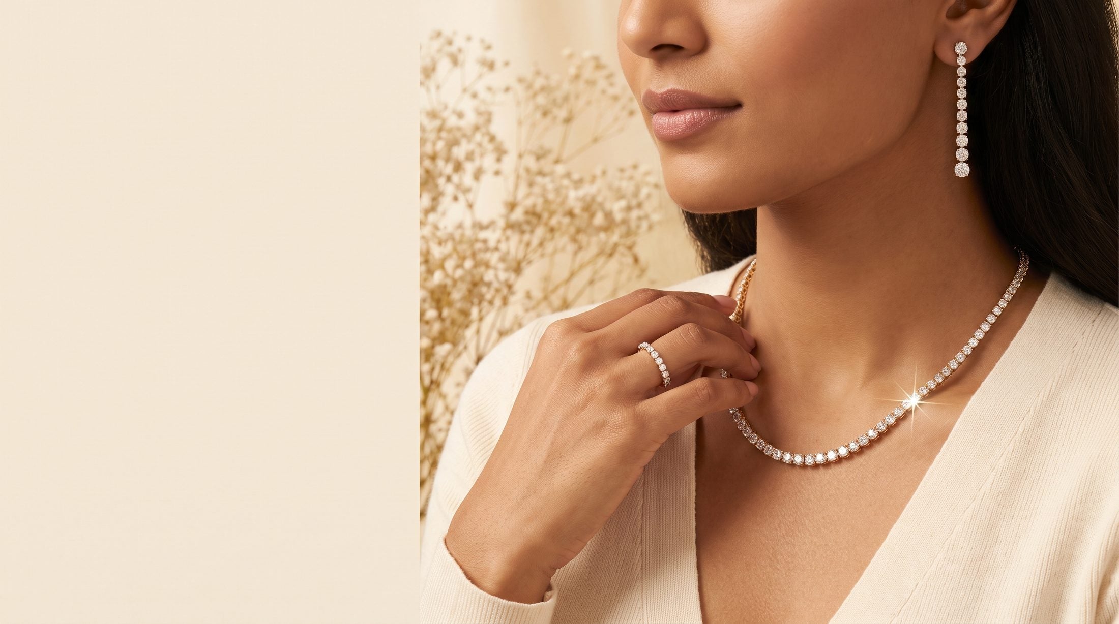 A woman wearing a lab-grown diamond tennis necklace and drop earrings